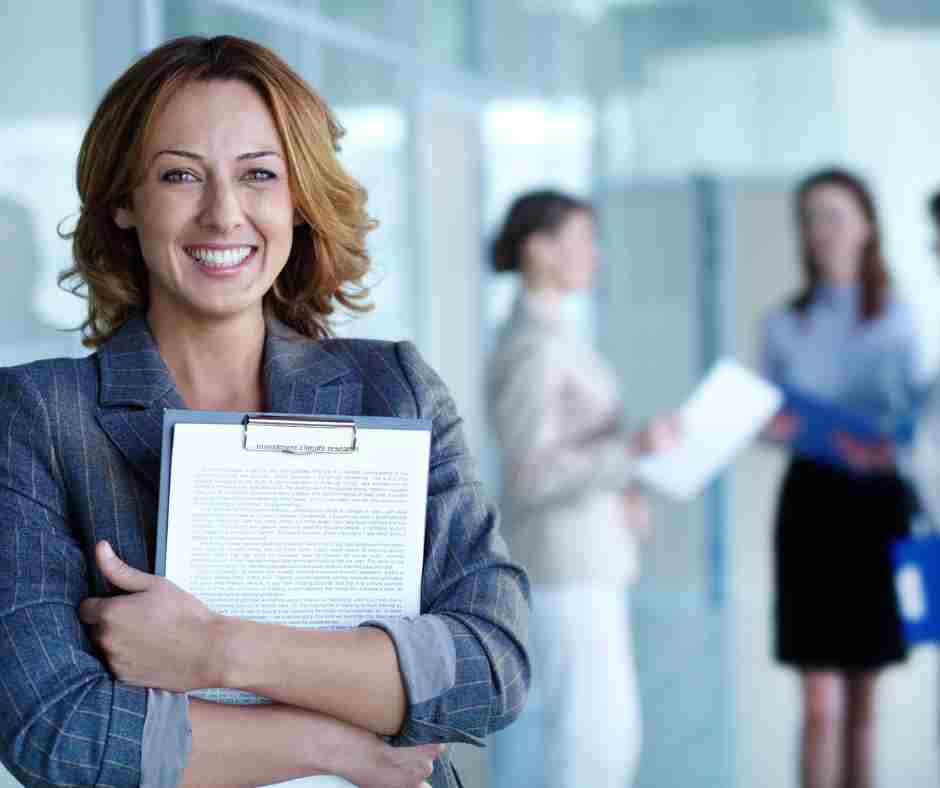 CHW employer Female person holds clipboard at work site.